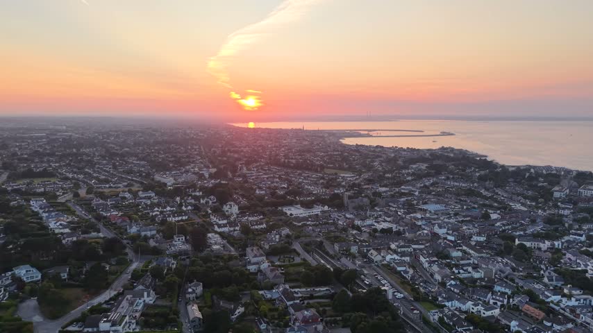 Wide aerial of Dublin cityscape from the south at vibrant sunset overlooking Dublin Bay, Ireland