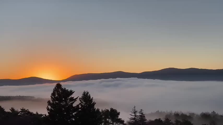 Sunrise over Mount Fuji with a beautiful sea of clouds and warm morning light in Japan. Scenic natural landscape at dawn.