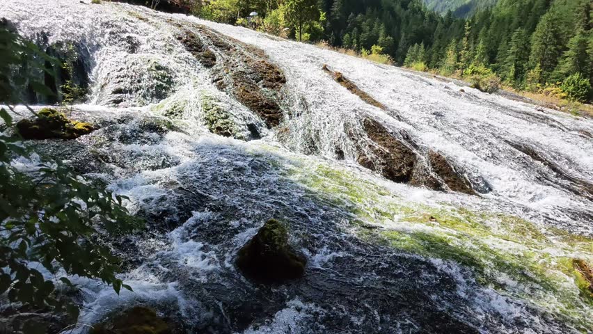 Jiuzhaigou 4K Close-Up of Water Flowing Down Rocks at Pearl Shoal Waterfall with Splashing Spray, Sichuan, China