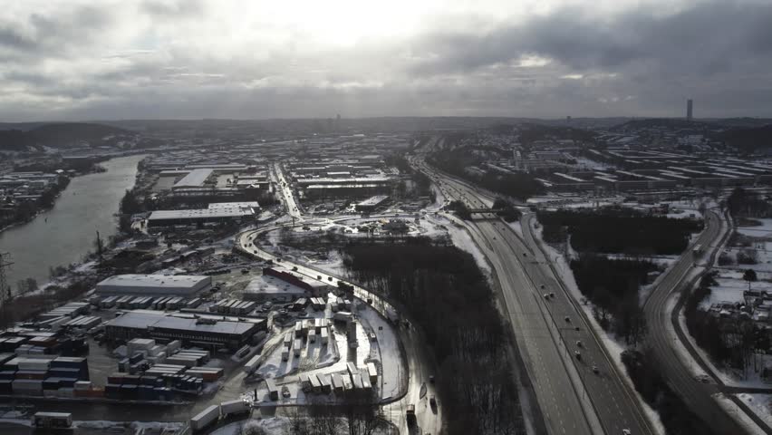 Aerial view of snowy E6 highway and industrial area in Backebol, Gothenburg winter