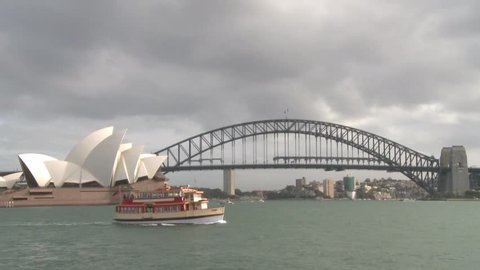 Ferry crossing Sydney Harbour in front of Harbour Bridge and Opera.