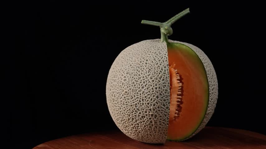 Orange Cantaloupe Melon Sliced Open on Black Background