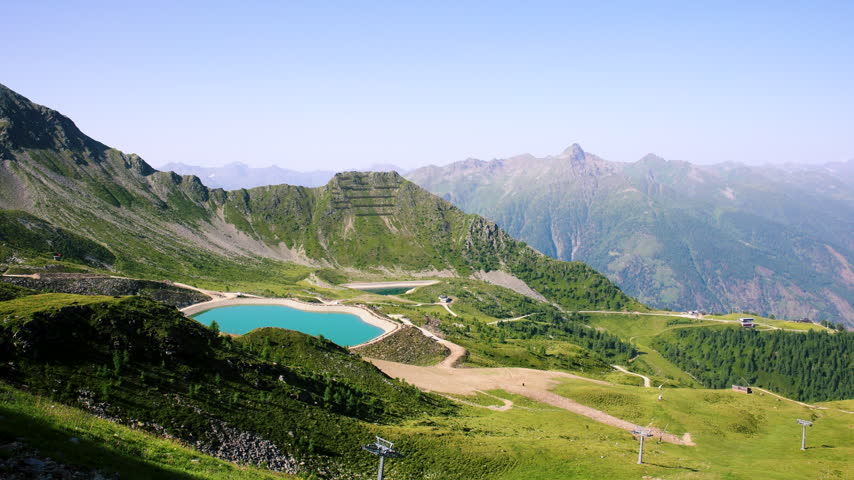Scenic alpine landscape Kals Grossglockner valley with blue artificial lake Tyrol mountains nature background. Panoramic view Alps summer hiking trail adventure tourism recreational area