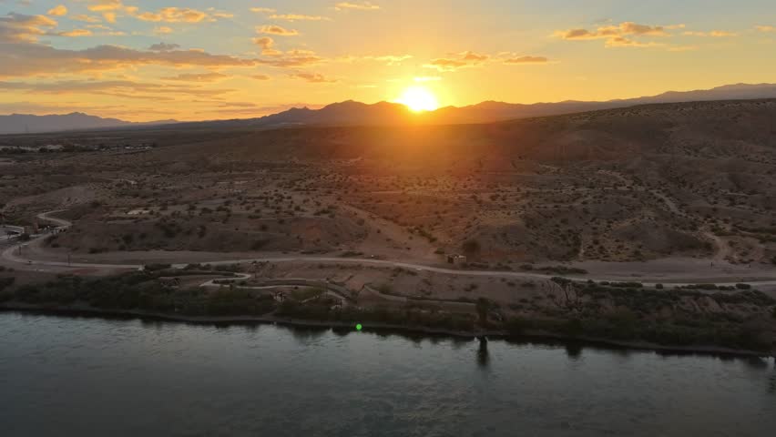 Beautiful footage of the Colorado River Trail in Laughlin, Nevada, capturing the natural contrast between the river corridor and surrounding Mojave Desert terrain. The recreational path, rocky ground, open horizon, and waterfront setting create versatile visuals for travel documentaries, outdoor recreation features, destination marketing, hiking content, regional tourism, and desert landscape productions.