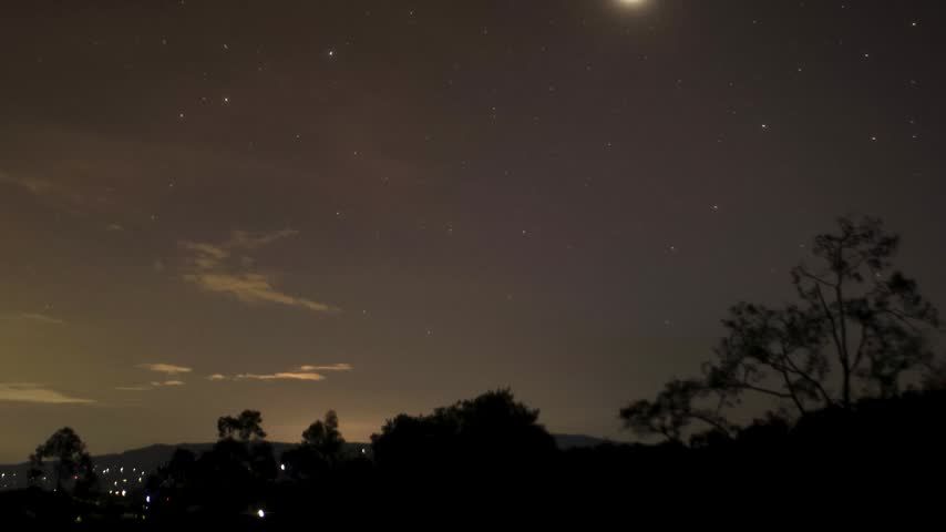 The bright of Venus and some stars is quickly covered by a dense cloud, in the night over the farms and forests of the eastern Andean mountains of central Colombia, near the Iguaque natural reserve.