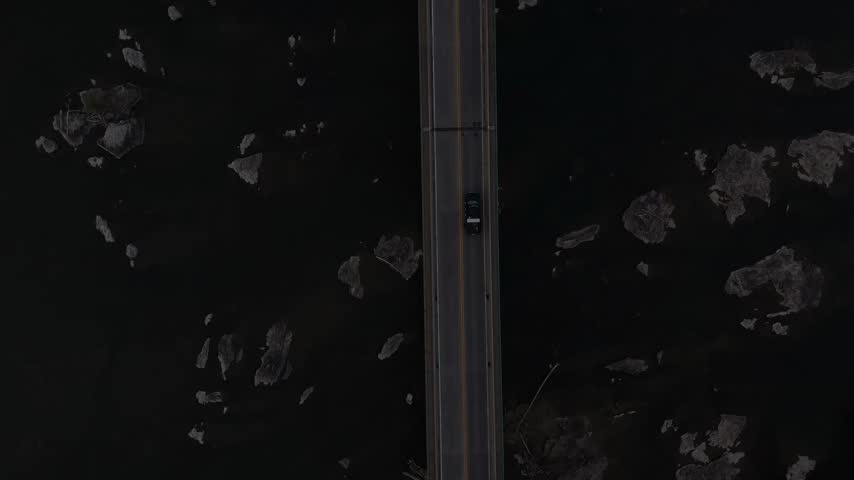 Top down aerial view of bridge crossing rocky Potomac River near Harpers Ferry West Virginia