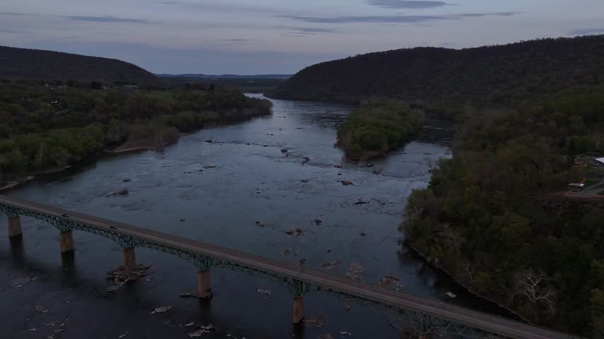 Aerial view of bridge crossing Potomac River near Harpers Ferry West Virginia at dusk