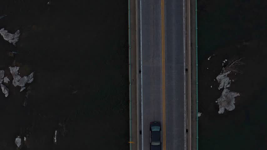 Top down aerial view of roadway bridge crossing Potomac River near Harpers Ferry West Virginia