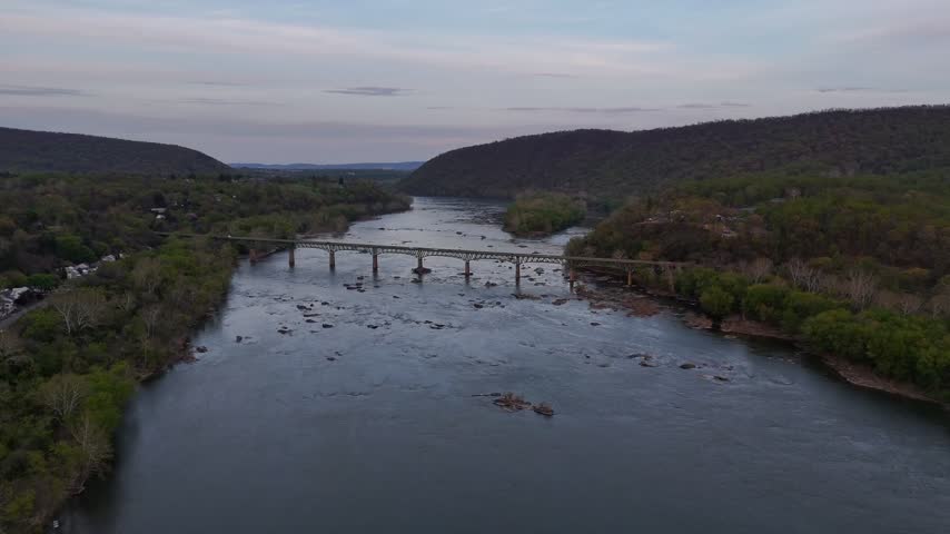 Wide aerial view of Potomac River and bridges near Harpers Ferry West Virginia at dusk