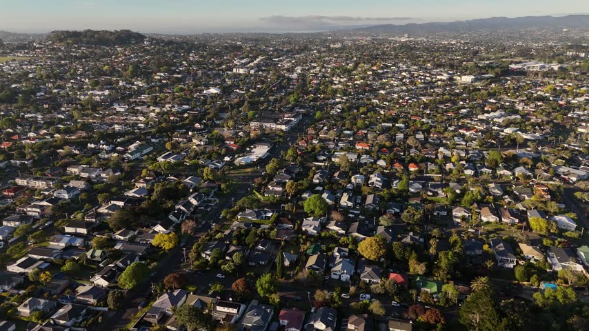 Auckland residential suburbs and green hills at sunset in Auckland, New Zealand