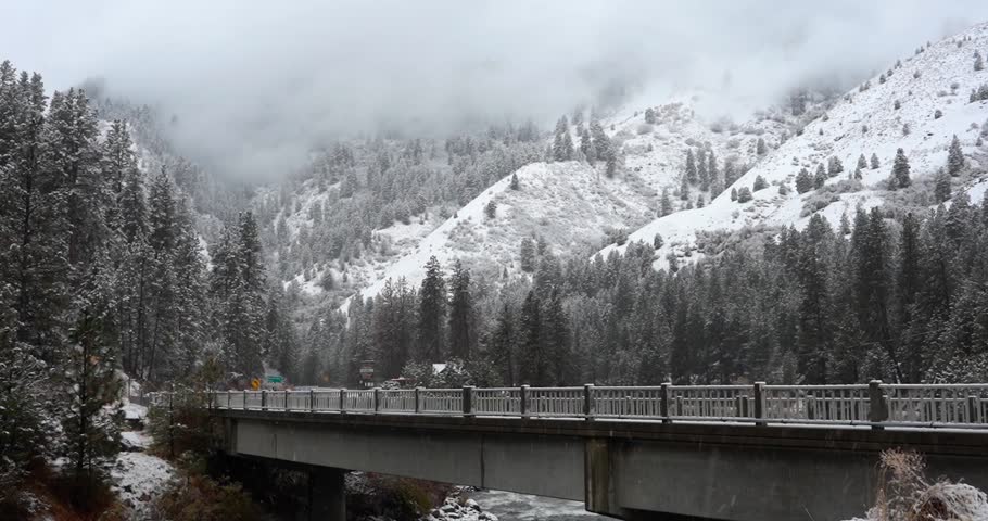 Bridge with mountain landscape during snowfall in Idaho