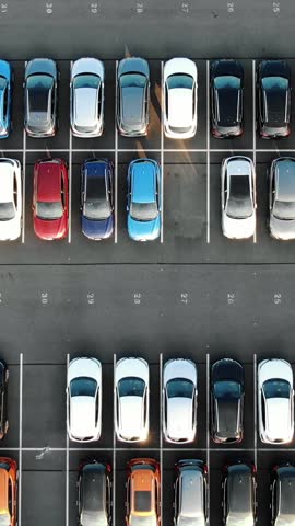 Giant outdoor parking lot filled with brand new cars ready for sale and distribution, highlighting the automotive industry's massive scale, export logistics, and vehicle storage
