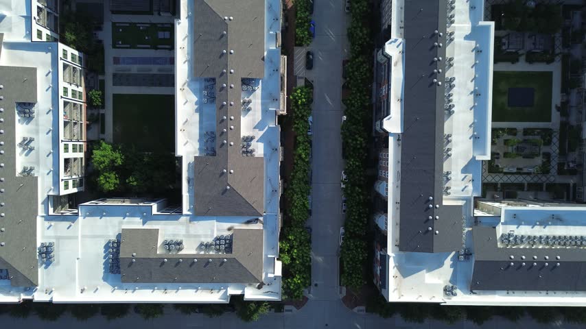 Perpendicular street layouts separate manicured residential gardens near Olympus Boulevard in Dallas suburbs. Overhead perspectives capture patterned rooftop arrays cleanly, Coppell, Texas. USA
