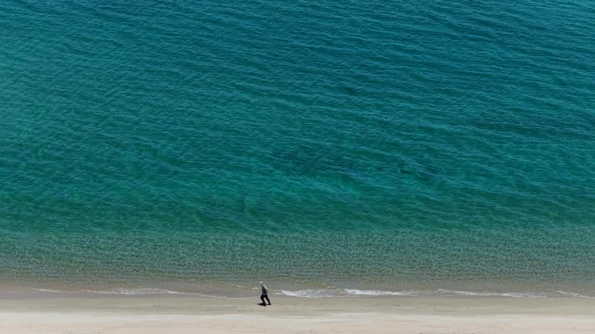 Aerial view of a fly fisherman walking on the beach in La Ventana, Sea of Cortes.