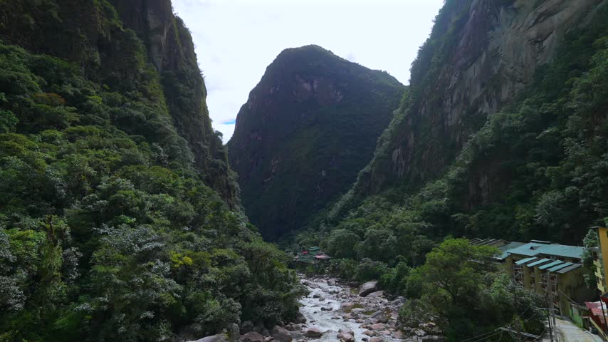 Aguas Calientes town Machu Picchu entrance Amazon Urabumba river dry rainy season afternoon Peru Peruvian Andes Mountains jungle lower highlands Inca trail citadel hotels landscape static shot