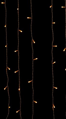 Golden garland lights on black background. New year or Christmas, versatile festive and magical backdrop.