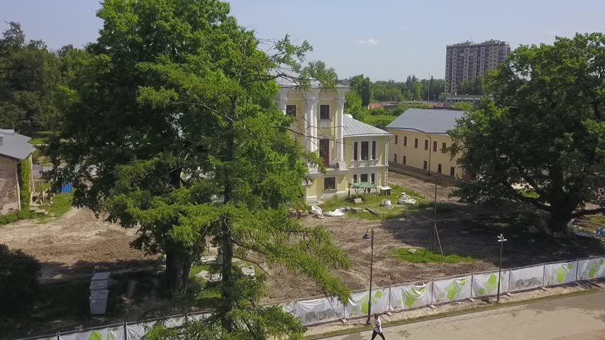 Drone orbits opposite the yellow manor house