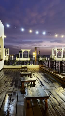 Beautiful evening view of the Suramadu Bridge seen from a waterfront dining area in Surabaya, Indonesia