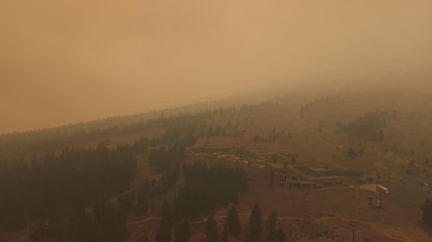 Drone footage of Timberline Lodge and surrounding slopes under dense wildfire smoke from the Grasshopper Fire, obscuring Mount Hood