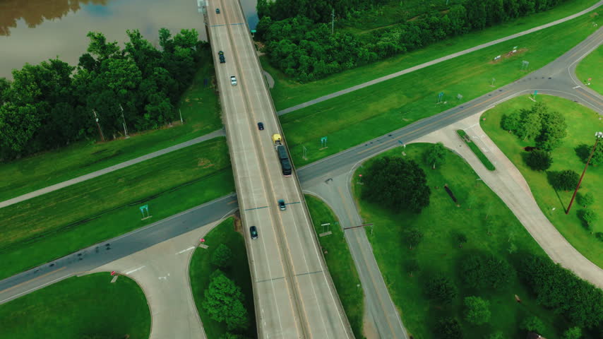 Elevated interstate crossing above a sediment-laden channel within the Atchafalaya Basin, the federally managed floodway that carries diverted Mississippi River flow to the Gulf.