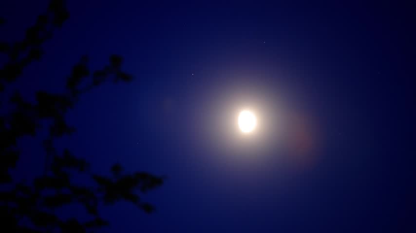 Moon on a twilight sky with landscape mountain silhouettes.