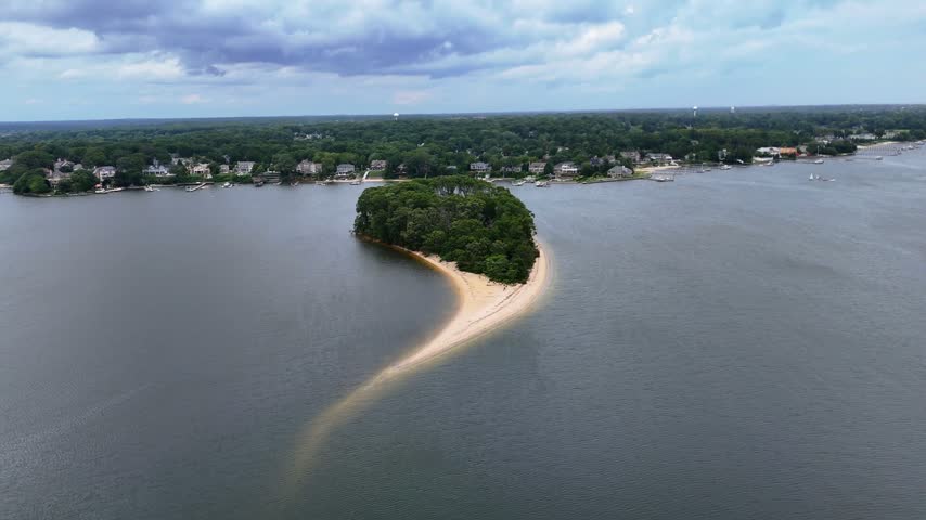 Aerial arc shot of Treasure Island on Manasquan River, with Point Pleasant shoreline