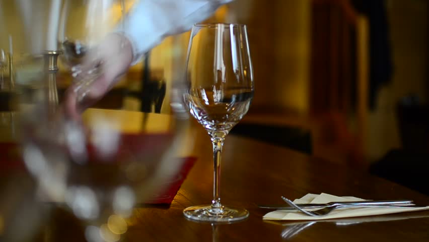 waiter prepairing glases in restaurant