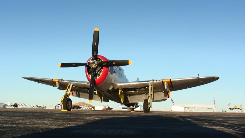 Historic warplane waiting at an airfield.