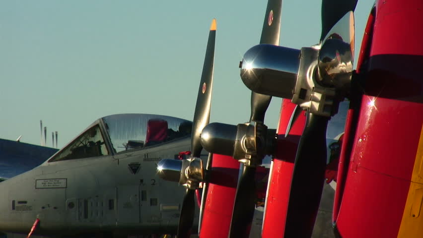 World War II Thunderbolts lined up in next to a modern A-10 Thunderbolt jet