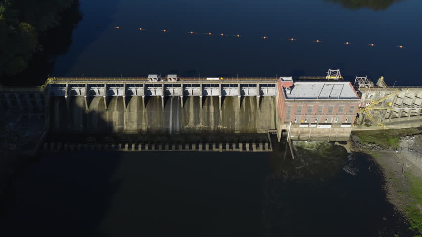 Wide aerial framing of Remmel Dam across calm reservoir, drone establishing overview, Ouachita River Jones Mill Arkansas USA