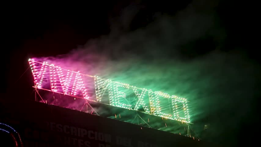 Viva Mexico pyrotechnic display with colorful sparks and smoke during a nighttime Independence celebration, creating a dramatic atmosphere for September 15 festivities and patriotic events