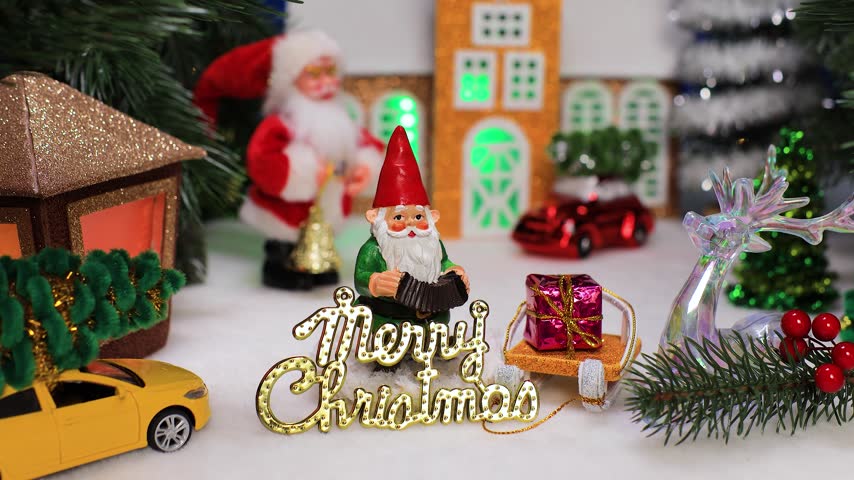 A gnome with letters against the background of the Santa Claus chapel
