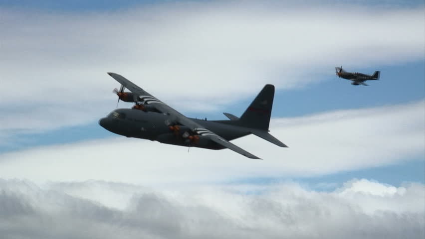 Lockheed Hercules military transport aircraft in flight.