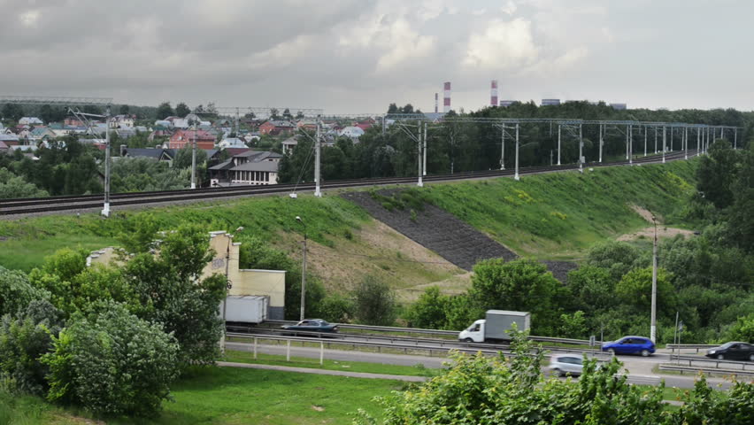 Cars going to a tunnel over which are passed by the train against the city of Moscow.Time lapse. | Shutterstock HD Video #4162354