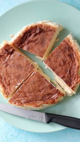 Homemade San Sebastian Basque burnt cheesecake slice on plate close-up