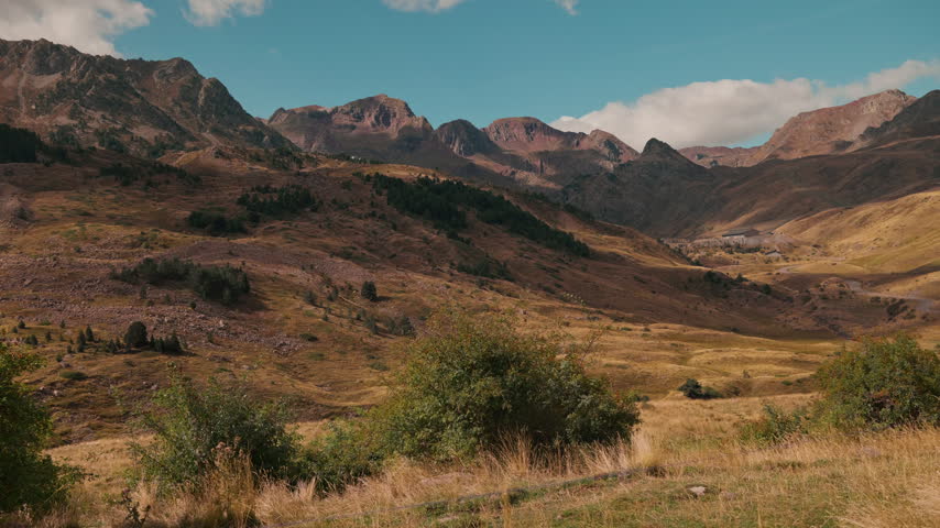 Scenic view of the valley near Hoz-de-Jaca, Spain. Oz de Tena area in Huesca, Aragon region. Beautiful Pyrenees mountains landscape with Sierra de Partacua ridge under a blue sky in summer.