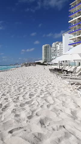 Caribbean sandy beach with turquoise water. Resorts along coastline for summer vacation. Tropical travel destination. Vertical footage