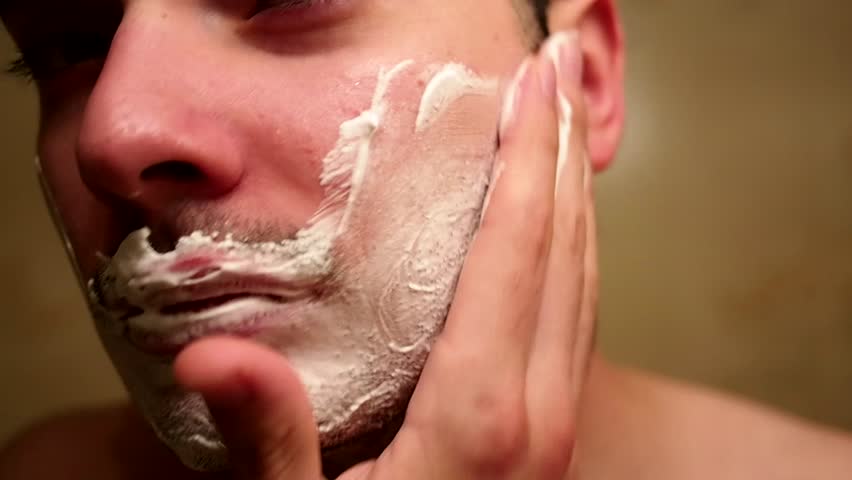 Man puts shaving cream on his face
