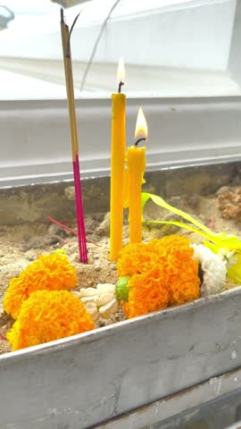 Candles, Incense Sticks and Thai Flower Garland in Joss Stick Pot in front of Chapel at the Temple, For Walk Around the Temple with a Candle at Bangkok, Thailand. 29 JUL 2026, A.M. Slow Down Video