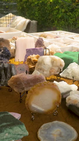 A collection of natural gemstones, amethyst, and quartz crystals on display. Suitable for wellness, spirituality, and alternative medicine content.