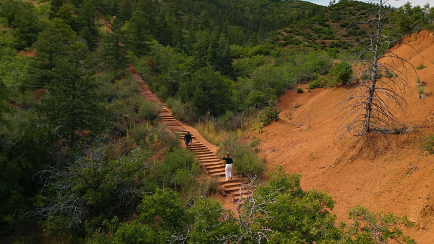 Flagstaff, USA, 24 August 2025: People go up and down the stairs to the mountain top. Hiking in the famous Manitou Springs Incline in Colorado, USA. Aerial view.