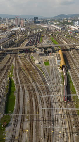 sunny day zurich city train station railways traffic aerial panorama 4k vertical timelapse switzerland