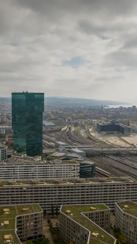day time zurich city modern office area train station railroad traffic aerial panorama 4k vertical timelapse switzerland