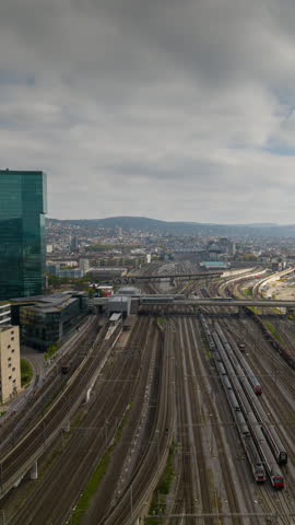 day time zurich city train station railroad traffic aerial panorama 4k vertical timelapse switzerland