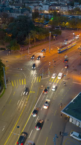 evening time illuminated zurich city center traffic street crossroad aerial panorama 4k vertical timelapse switzerland 
