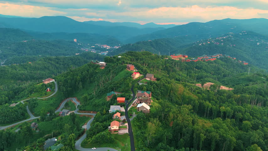 Beautiful homes in Gatlinburg, Tennessee nestled in the Great Smoky Mountains with scenic forest landscape and summer colors