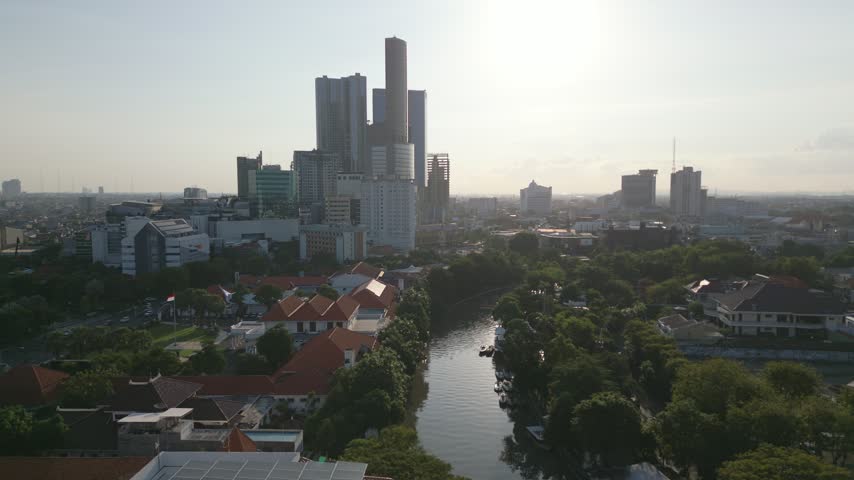 Surabaya river and Tunjungan Plaza skyline aerial panorama before sunset