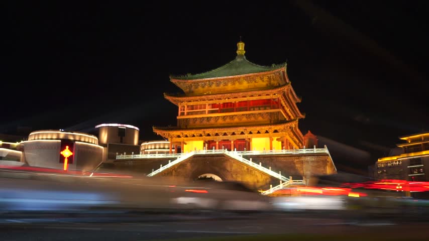 Low wide angle view of Bell tower in the night while traffic was moving