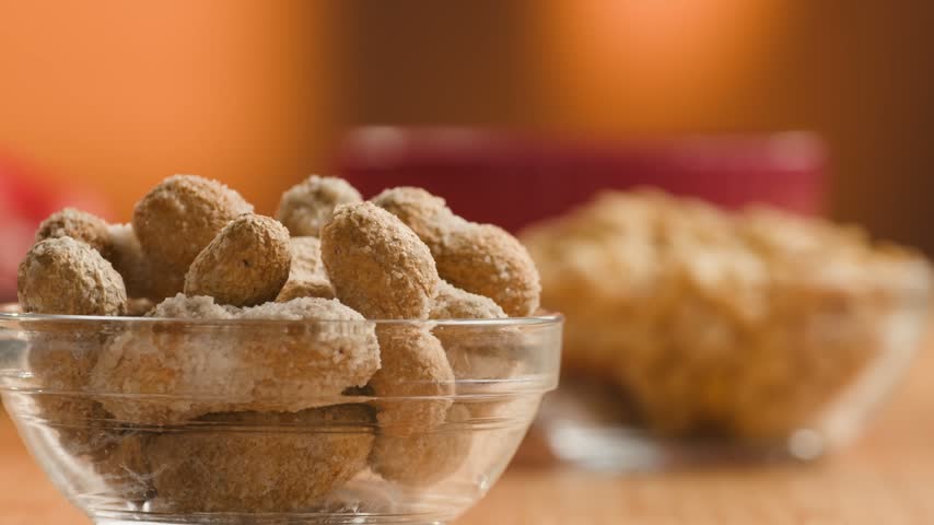 Peanuts in Salted Shell Man Cracking and Eating Salty Nuts as a Classic Bar Snack at Cafe