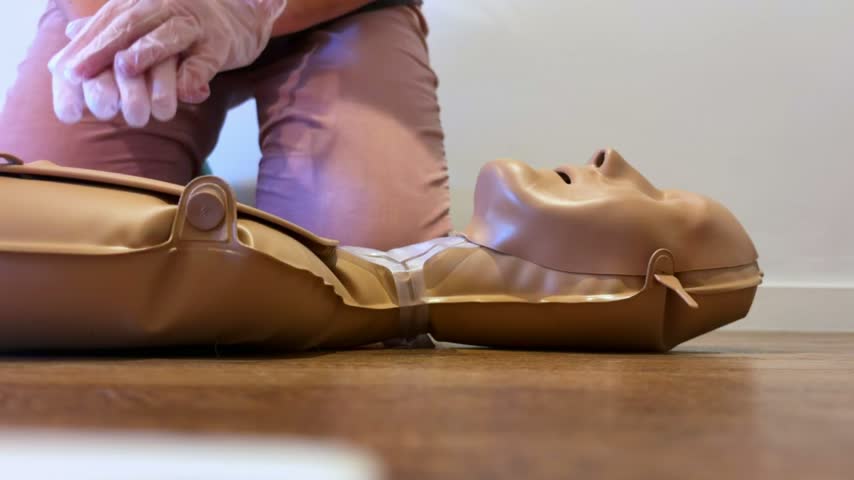 CPR Training on a portable adult manikin AED trainer